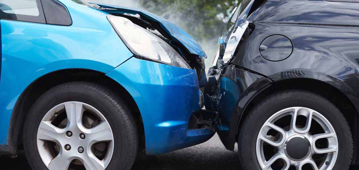 A blue car crashes into the back of a black car